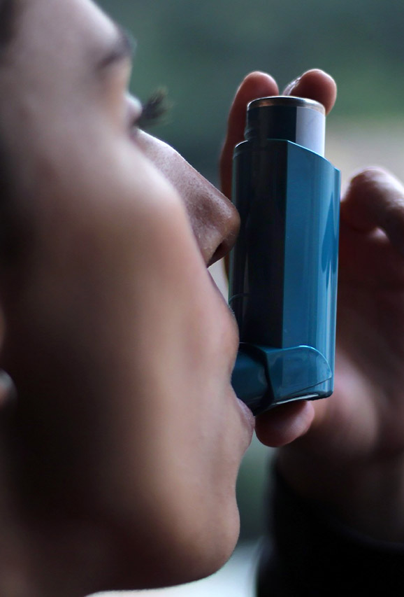 Photo of a woman using an inhaler