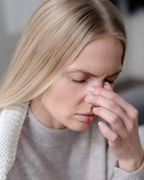 Photo of a woman sick at home with sinusitis