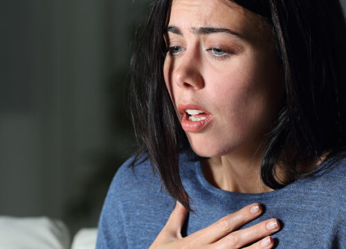 Photo of a woman with asthma trying to catch her breath